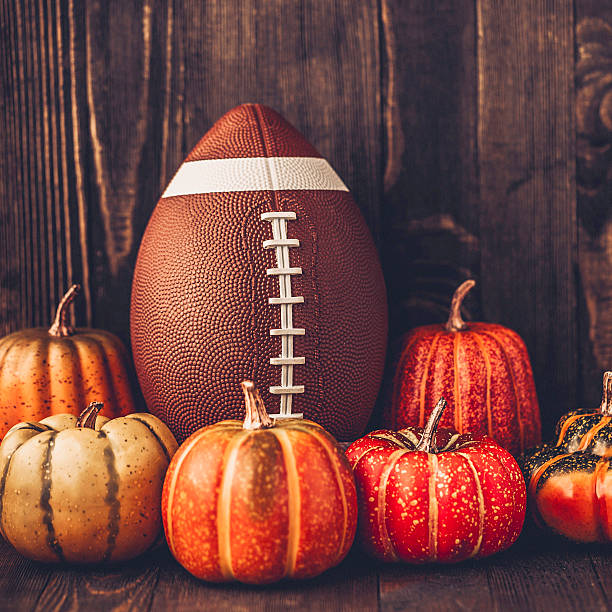 istock American football with assorted pumpkins 597931562