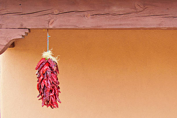 istock Chili Peppers Ristras Against Santa Fe Stucco Wall 597932222