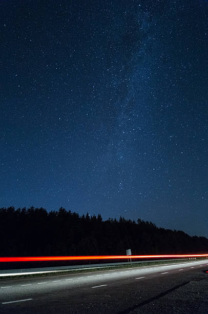 istock Driving at night. The light trails on the street 597933394