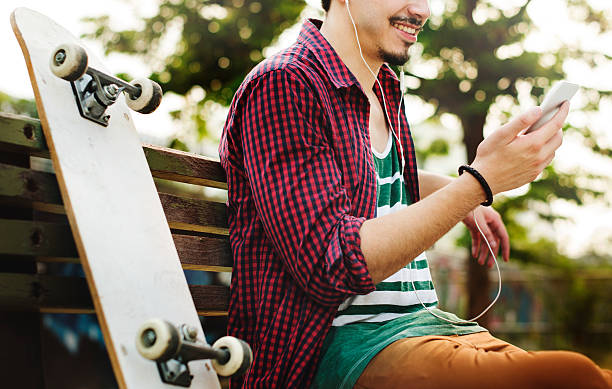 istock Skateboarding Sitting Relaxation Park Holiday Concept 597933774
