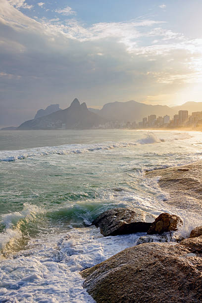 Arpoador beach Arpoador beach in Rio de Janeiro, with its stones, buildings and the seaside during sunset and the Two Brothers hill in background two brothers mountain stock pictures, royalty-free photos & images