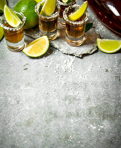 istock Tequila with salt and lime slices. 597934214