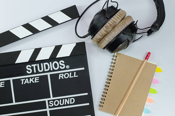 istock Slate film and notebook headphone white background 597934254