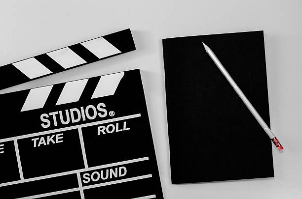 istock Slate film and black notebook white background 597934286