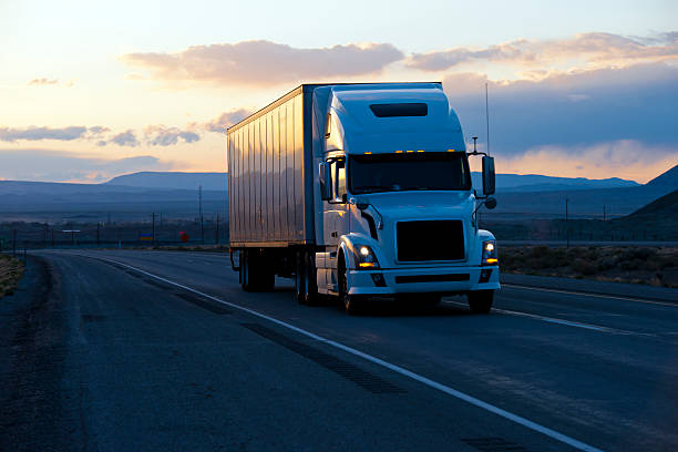 istock Modern semi truck trailer on twilight highway 597935308