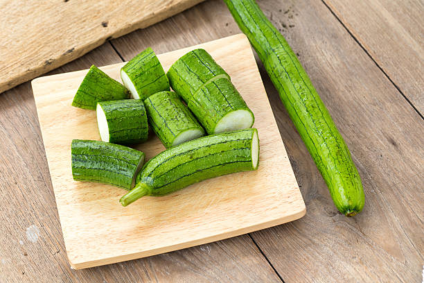 istock Snake gourd on wooden background 597936812