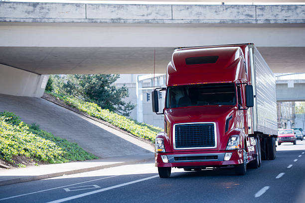 istock Red modern semi truck with reefer trailer under bridge 597936952
