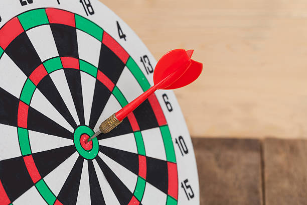 istock Dart arrow hitting in bullseye on dartboard 597938930