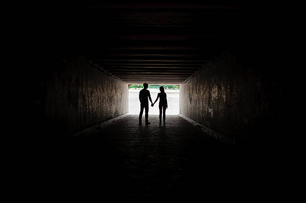 istock Silhouette of young couple holding hands 597941316