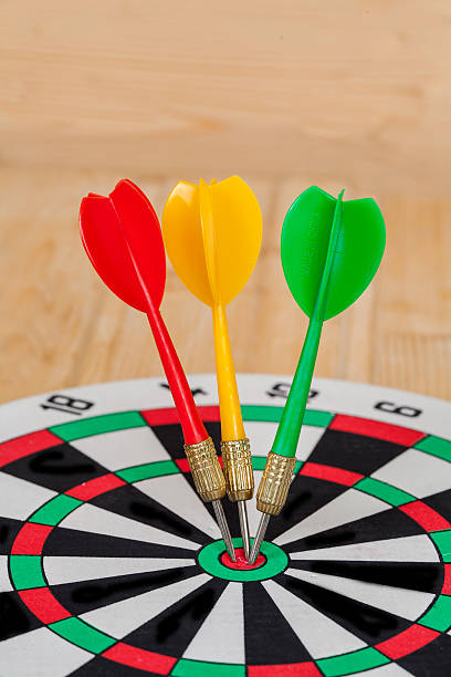 istock Dart arrow hitting in bullseye on dartboard 597943408