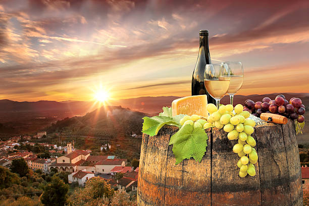 istock White wine with barrel on famous vineyard in Chianti, Italy 597946158