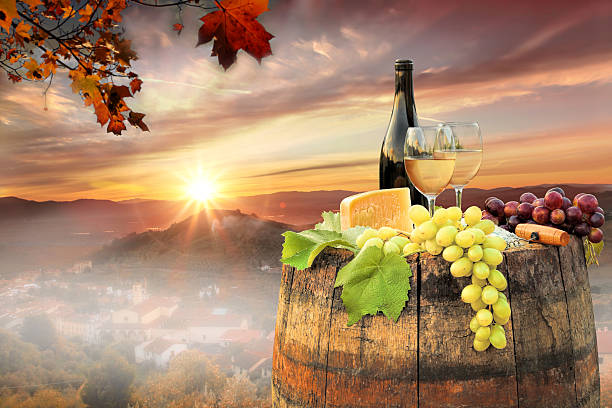 istock White wine with barrel on famous vineyard in Chianti, Italy 597946198
