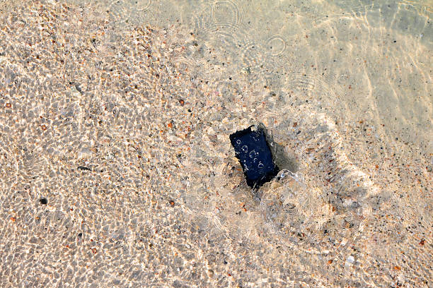istock Mobile phone fall to the sea water. 597948114