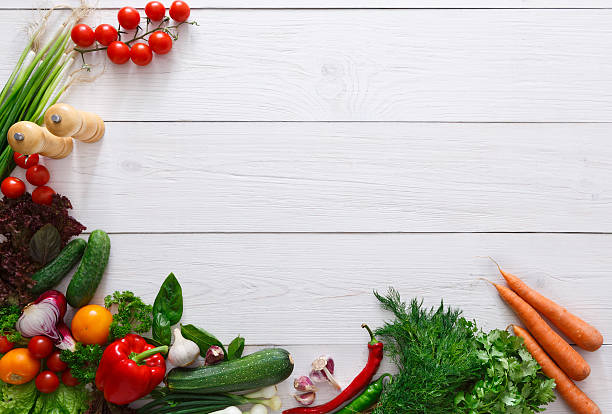 istock Fresh vegetables frame on white wooden background with copy space 597949076