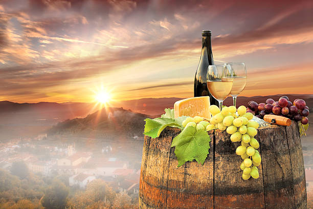 istock White wine with barrel on famous vineyard in Chianti, Italy 597949106
