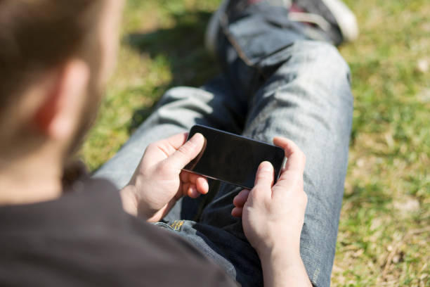 istock young man holding smart phone 597949722