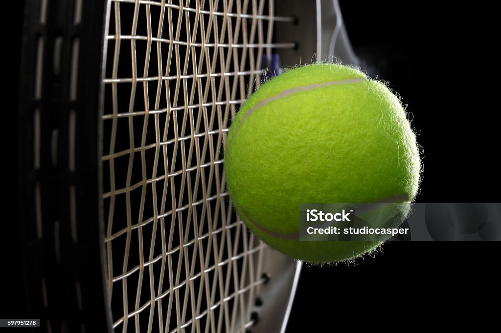 tennis racket with tennis ball A tennis racket with tennis ball on a black background Tennis Ball Stock Photo