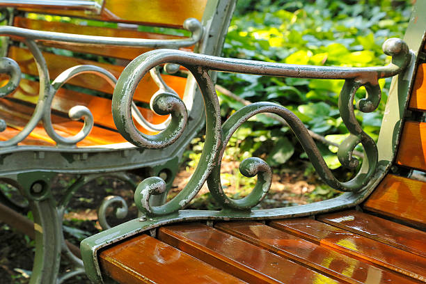 istock Bench in the sunshine filtering through foliage 597951692