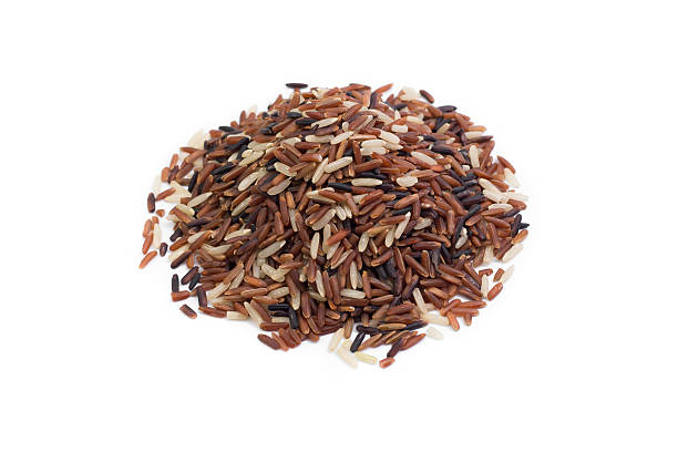 istock pile of brown rice isolated on white 597952312