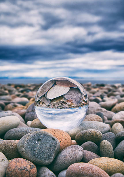 Crystal Ball And Stony Beach A crystal ball sitting on a stony beach in Scotland. Shot in Findhorn, Scotland. moray firth stock pictures, royalty-free photos & images