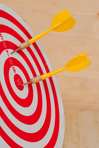 istock Dart arrow hitting in bullseye on dartboard 597953564