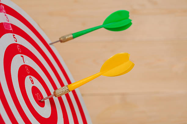 istock Dart arrow hitting in bullseye on dartboard 597953596