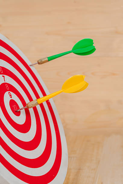 istock Dart arrow hitting in bullseye on dartboard 597953648