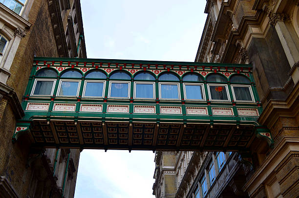 istock passageway connecting two british buildings with arch windows uk london 597954494