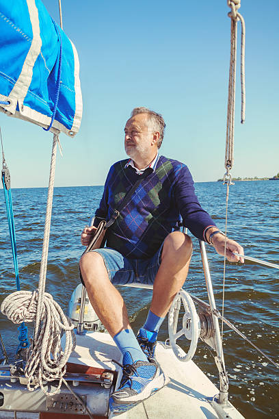 istock elderly man on yacht at sea 597954760