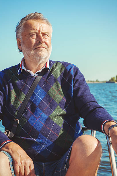 istock elderly man on yacht at sea 597954870