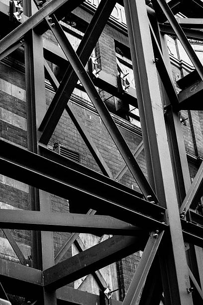 istock Scaffolding against a brick building in black & white 597955108