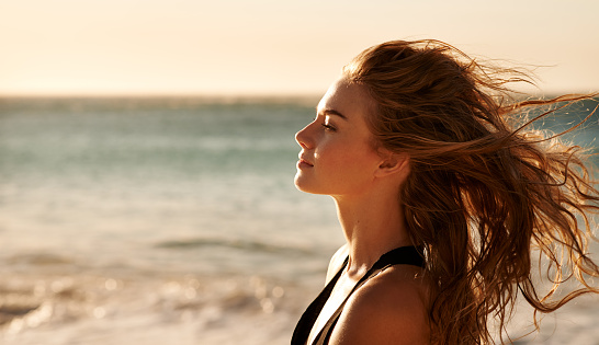 Shot of a beautiful young woman on the beach