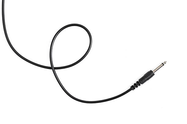 istock Guitar audio jack with black cable isolated on white background 597955660