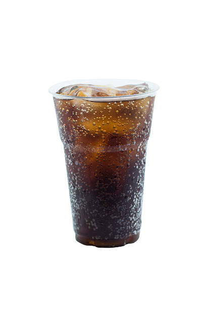 istock cola drink in plastic glass with ice isolated on white 597956478