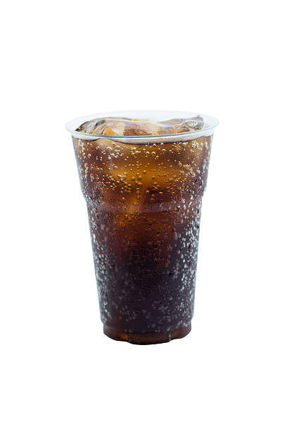 istock cola drink in plastic glass with ice isolated on white 597956522