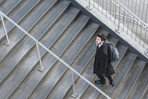 istock Businessman walking up stairs on work commute 597957042