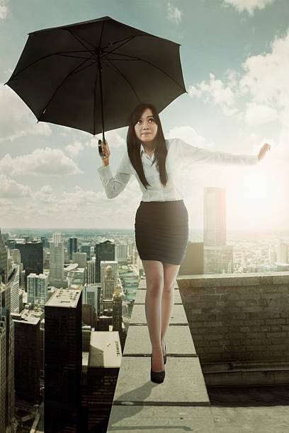 istock Woman with umbrella walks on rooftop 597957874
