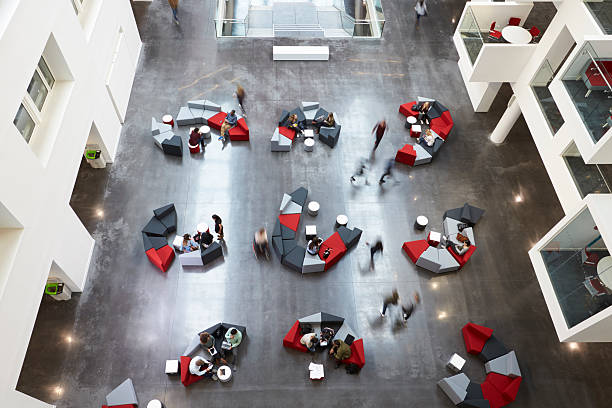 istock Overhead view of seating in a university atrium, motion blur 597957894