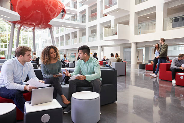 istock Students in university atrium, three in foreground close up 597957916