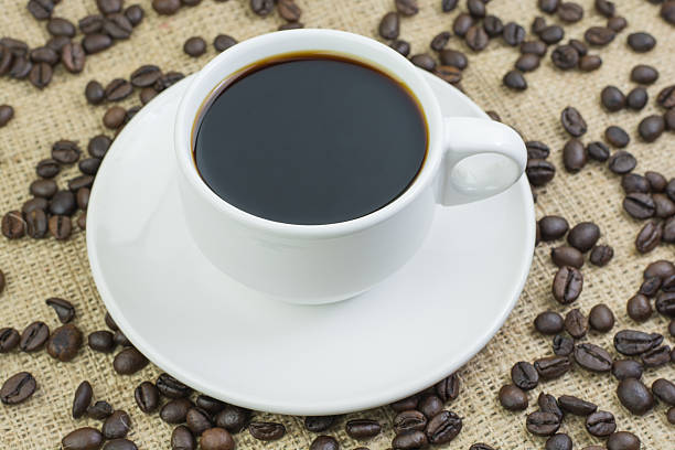 istock White cup with coffee drink on jute bag background 597958508
