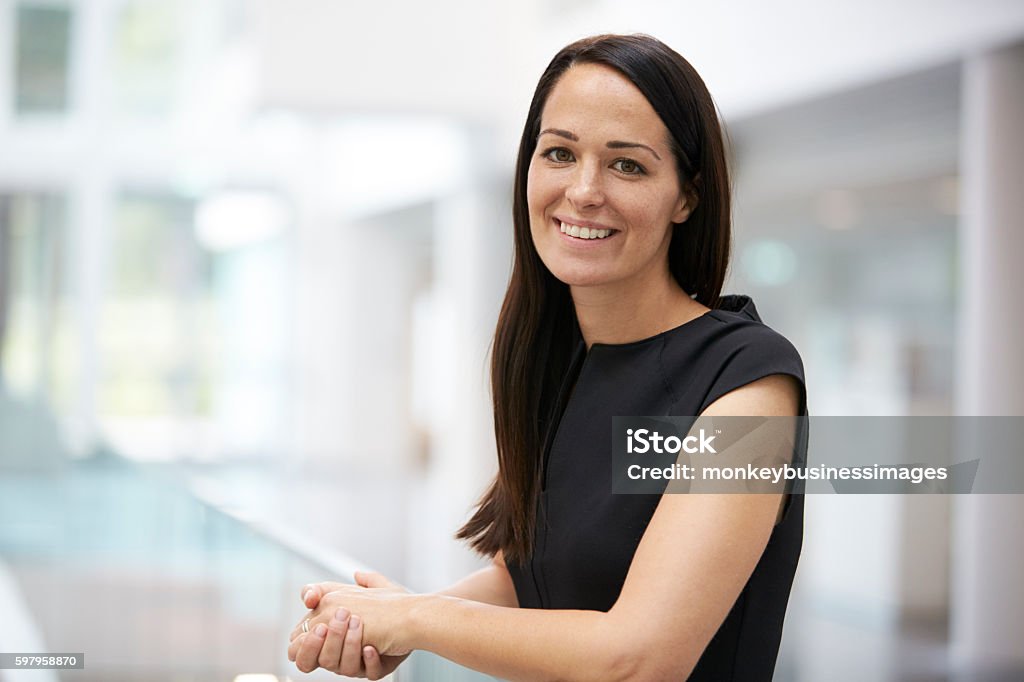 Portrait of young woman in modern university interior UK Stock Photo