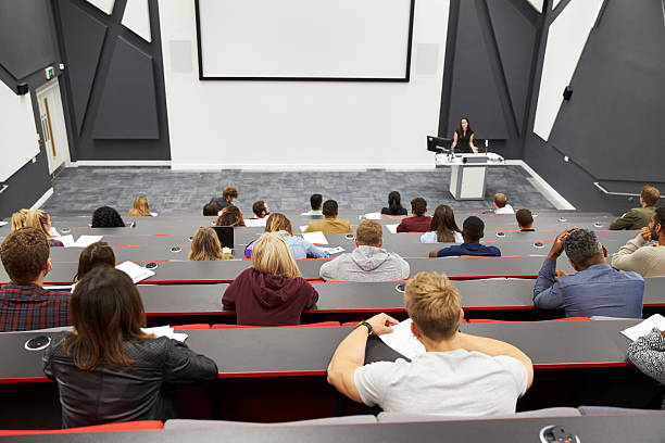 istock Lecture at university lecture theatre, audience POV 597959098