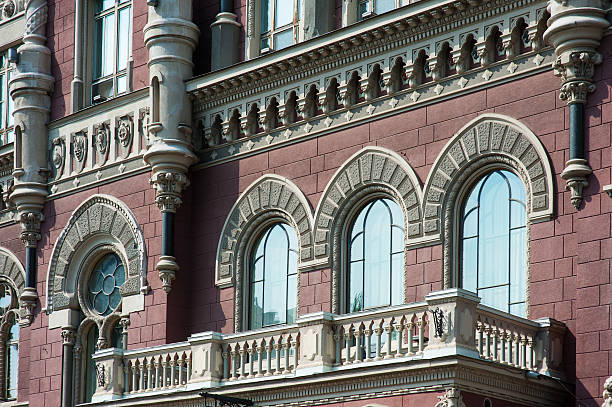 A close up of distinctive facades of London residential and business properties in central district within the City of Westminster with ornate windows and architectural details.