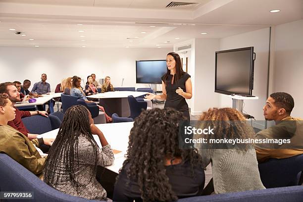 Female Teacher Addressing University Students In A Classroom Stock Photo - Download Image Now