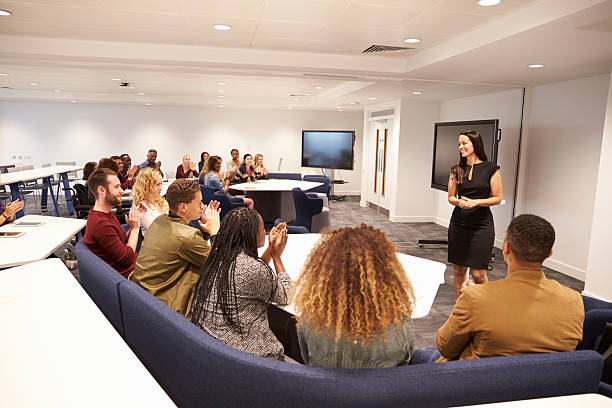 istock Female teacher addressing university students in a classroom 597959390