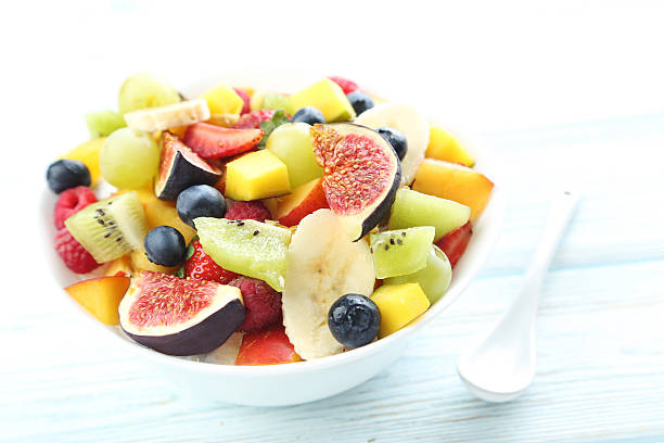 istock Fresh fruit salad on a white wooden table 597959466