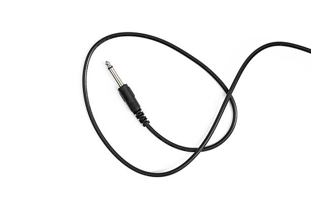 istock Guitar audio jack with black cable isolated on white background 597959600