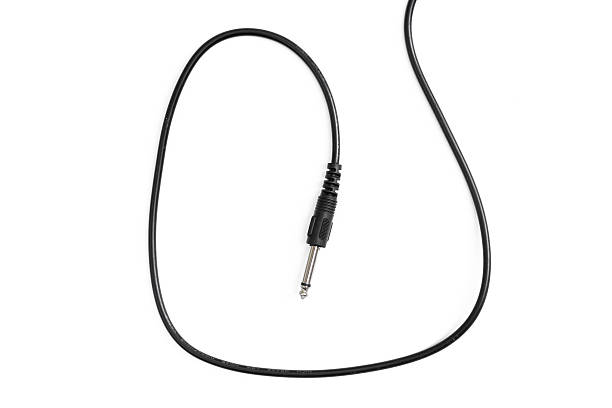 istock Guitar audio jack with black cable isolated on white background 597959622