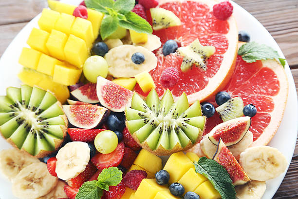 istock Fresh fruit salad on a brown wooden table 597959714