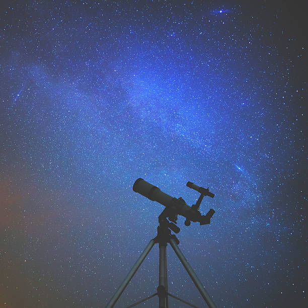 istock Silhouette of a telescope with starry skies. 597960962